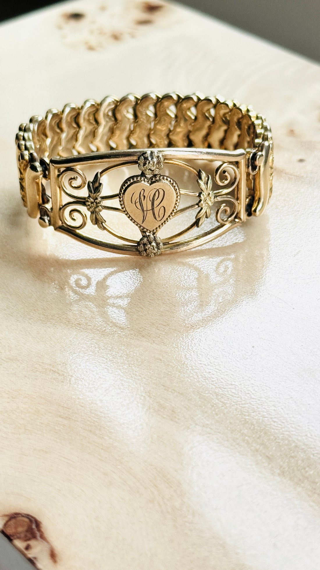 Antique gold filled bracelet with engraved H monogram, shown at an angle