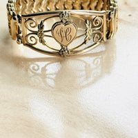 Antique gold filled bracelet with engraved H monogram, shown at an angle