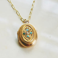 Antique gold locket necklace with floral motif and beaded border detail, hipV