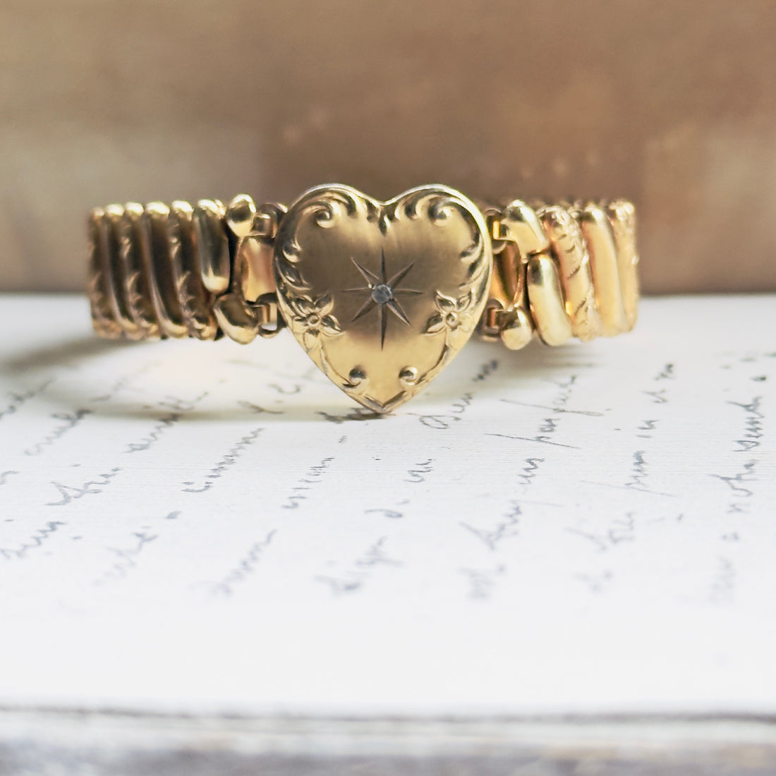 Antique gold sweetheart bracelet featuring engraved scrollwork heart with star-set diamond, ribbed expansion band, hipV Modern Vintage