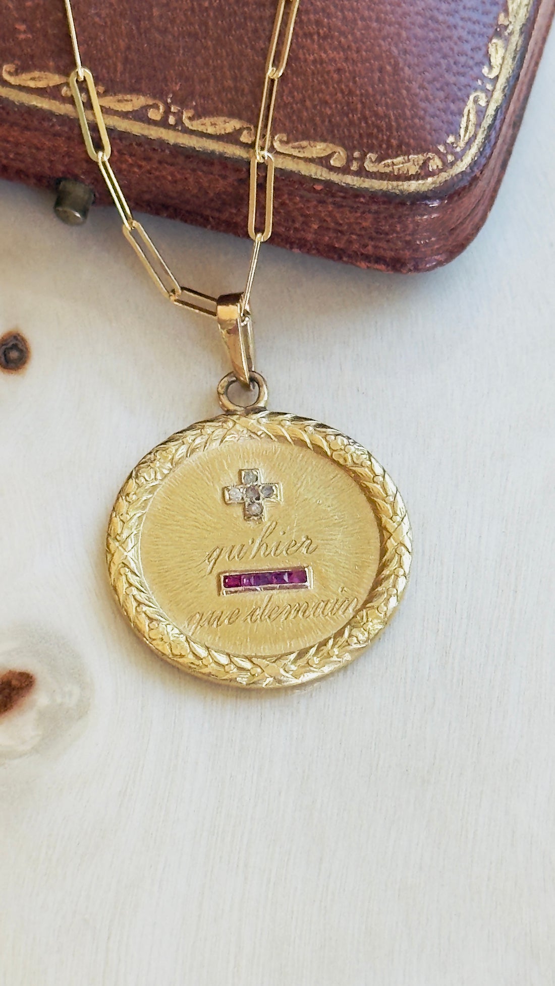 Augis love medal with laurel wreath detail suspended from gold paperclip chain