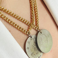 Silver coin necklace on gold chain