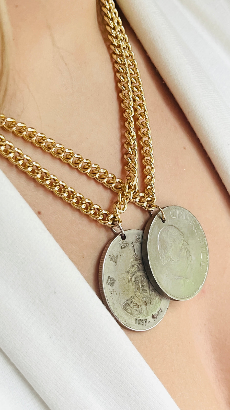 Silver coin necklace on gold chain