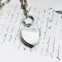 Back of antique sterling silver Art Deco heart locket pendant with smooth polished reverse.