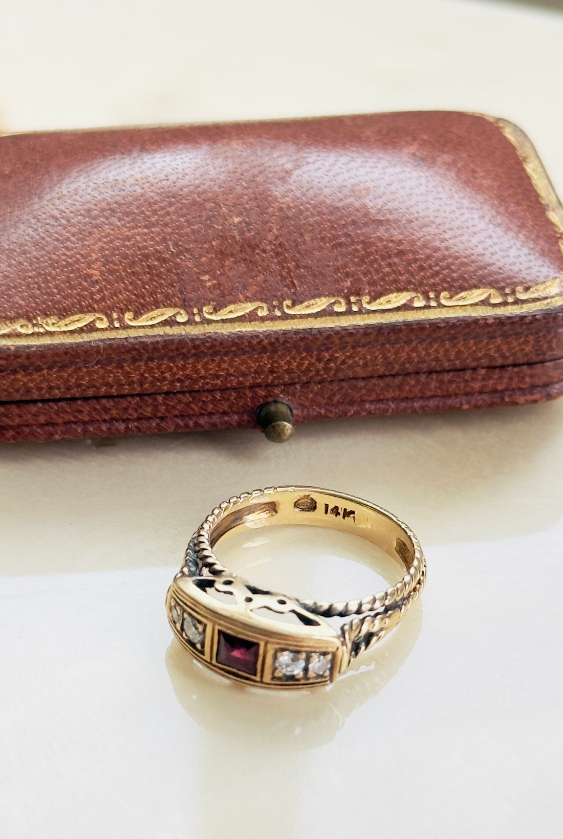Bold statement ruby ring with crown motif and rope twist shoulders