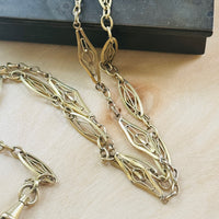 Close-up detail of the antique French ORIA watch chain featuring original dog clips and distinctive elongated links.