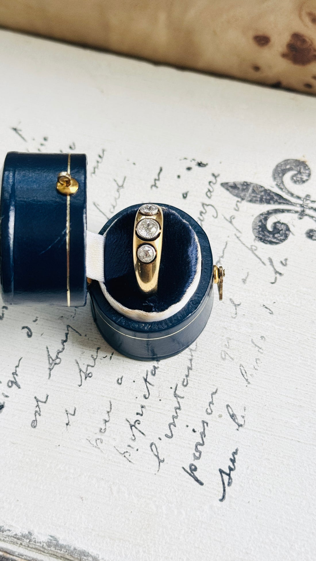 Close-up of an antique gold and platinum diamond ring in its presentation box