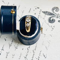 Close-up of an antique gold and platinum diamond ring in its presentation box