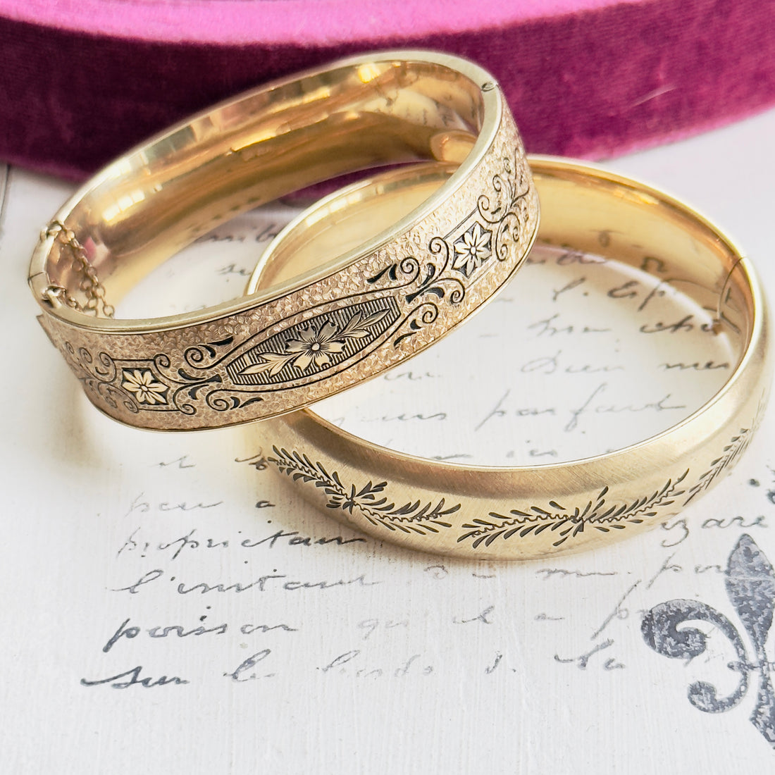 Close-up of etched detail on gold bangle bracelet.
