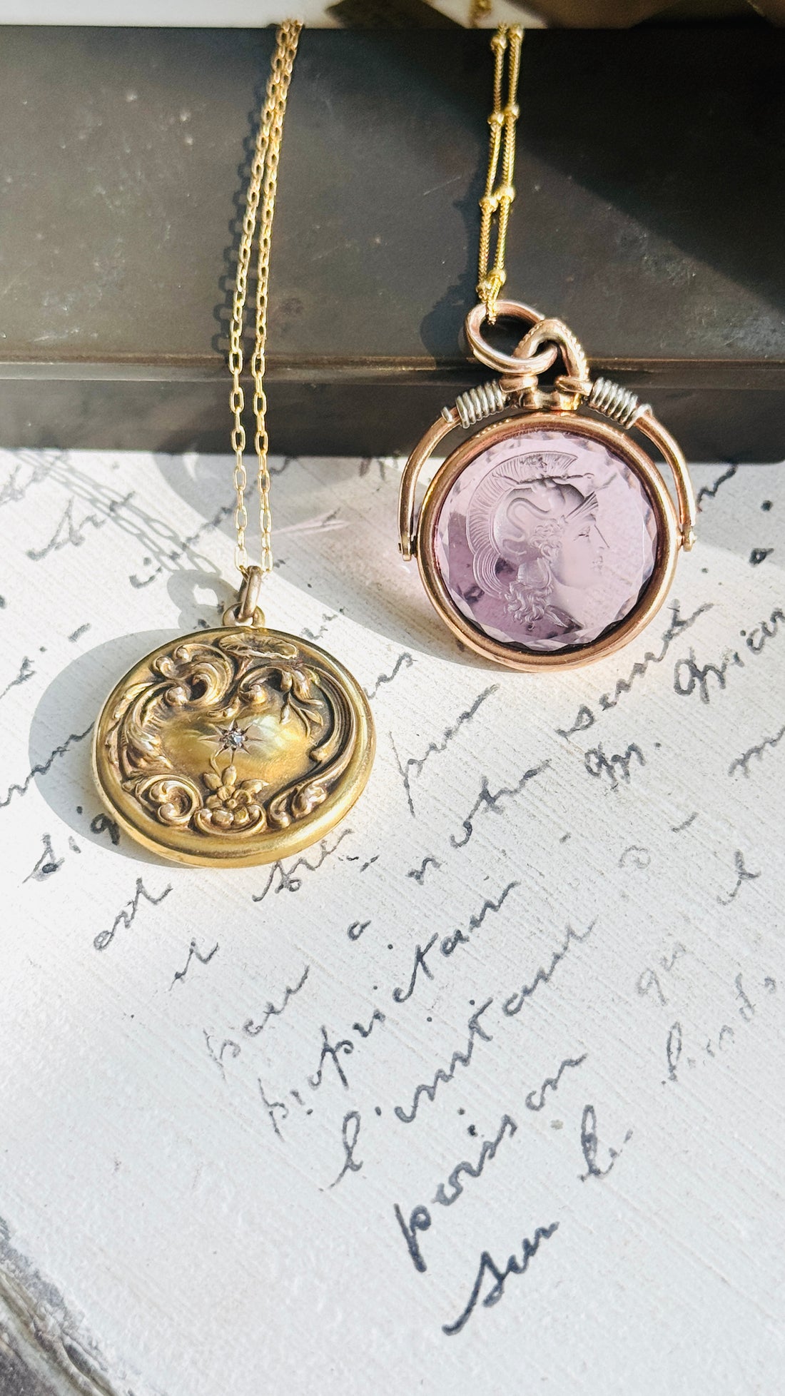 Close-up of original antique 14K gold diamond locket with repoussé detailing.