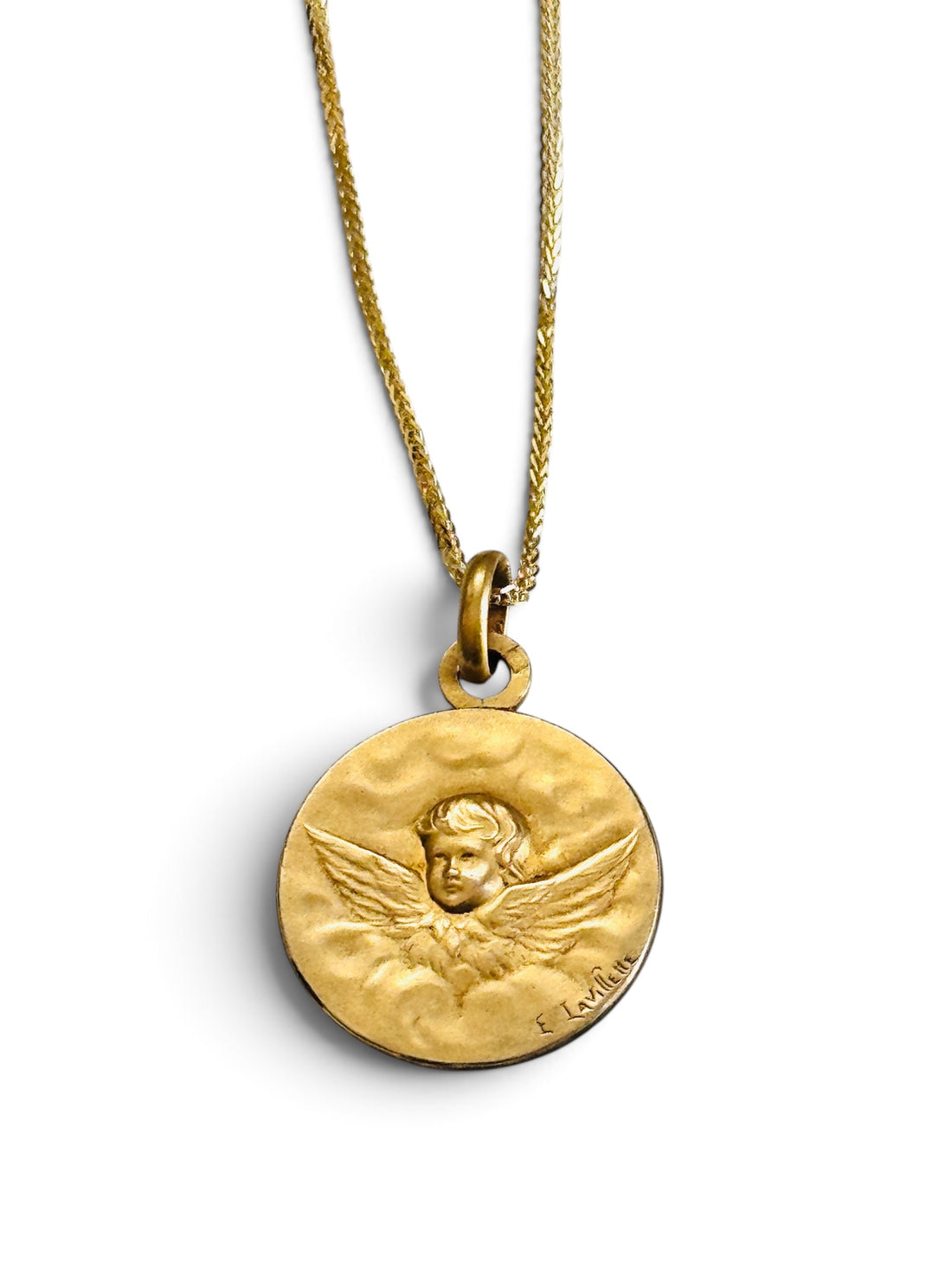 Close-up of signed French Art Nouveau FIX cherub medal in 18k gold-filled metal.