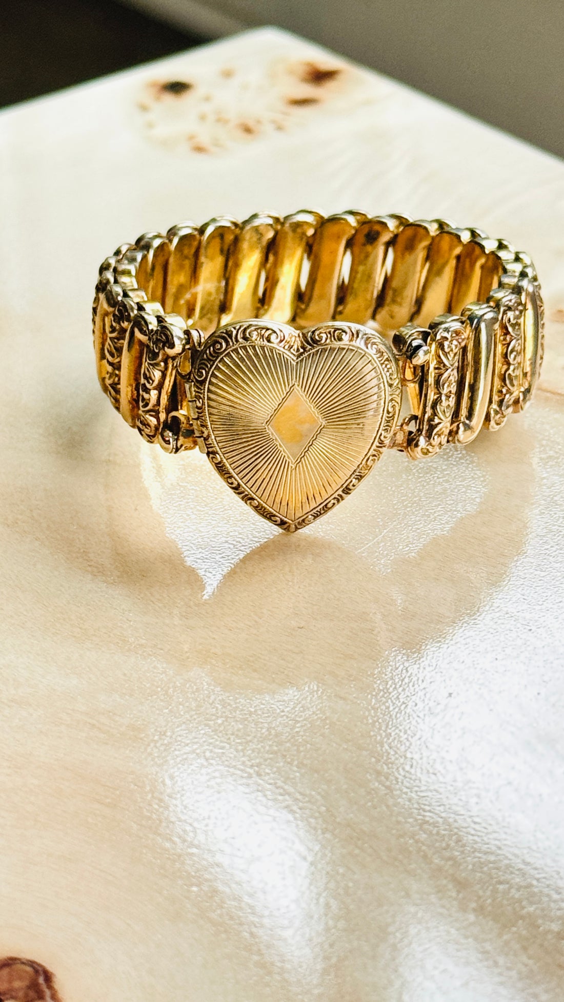 Close-up of sunburst engraved heart locket on antique Ladifair sweetheart bracelet