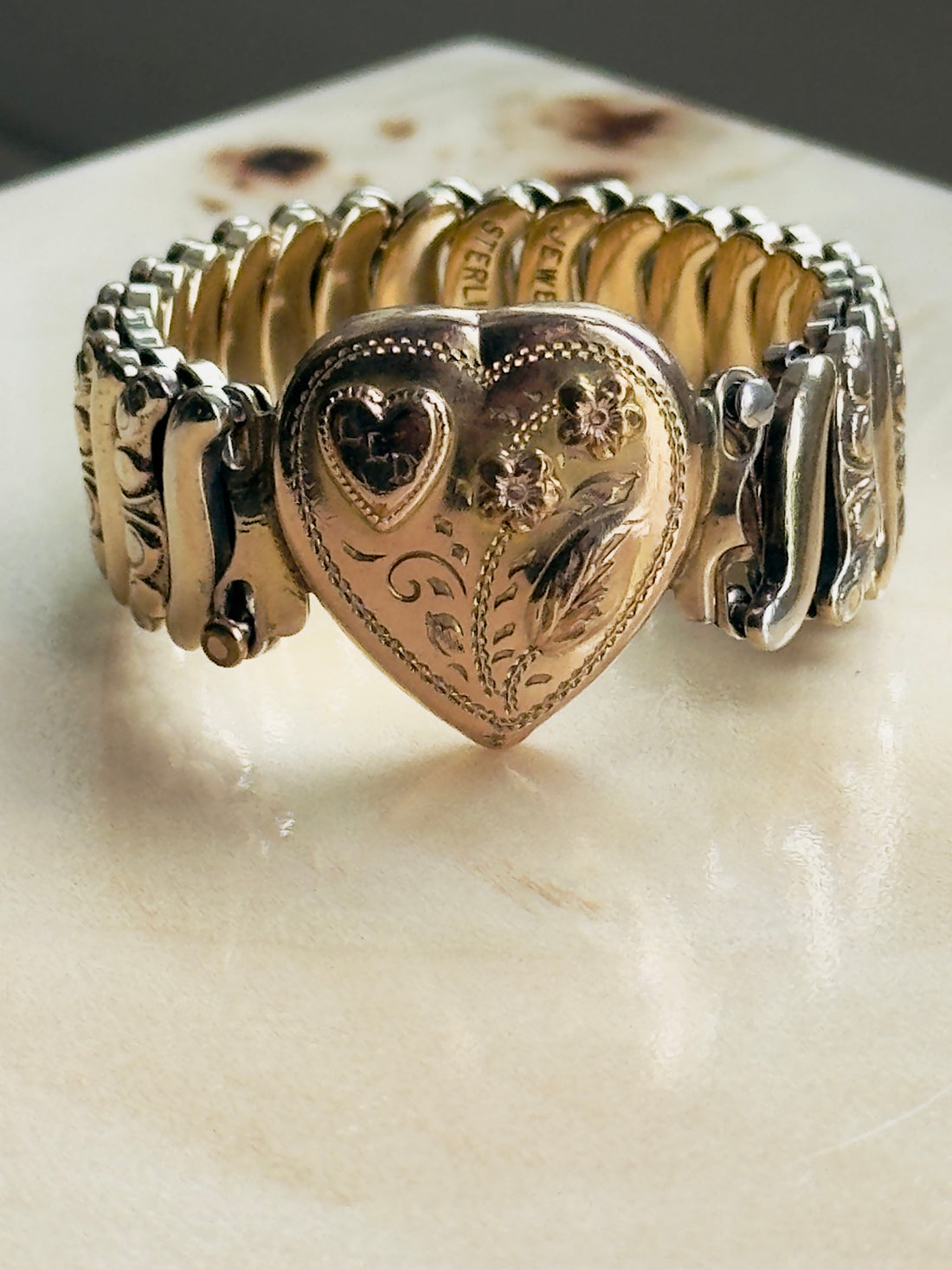 Collectible signed Jewel Guild sweetheart bracelet, gold filled over sterling with hand-engraved floral scrollwork and pink enamel flower heads
