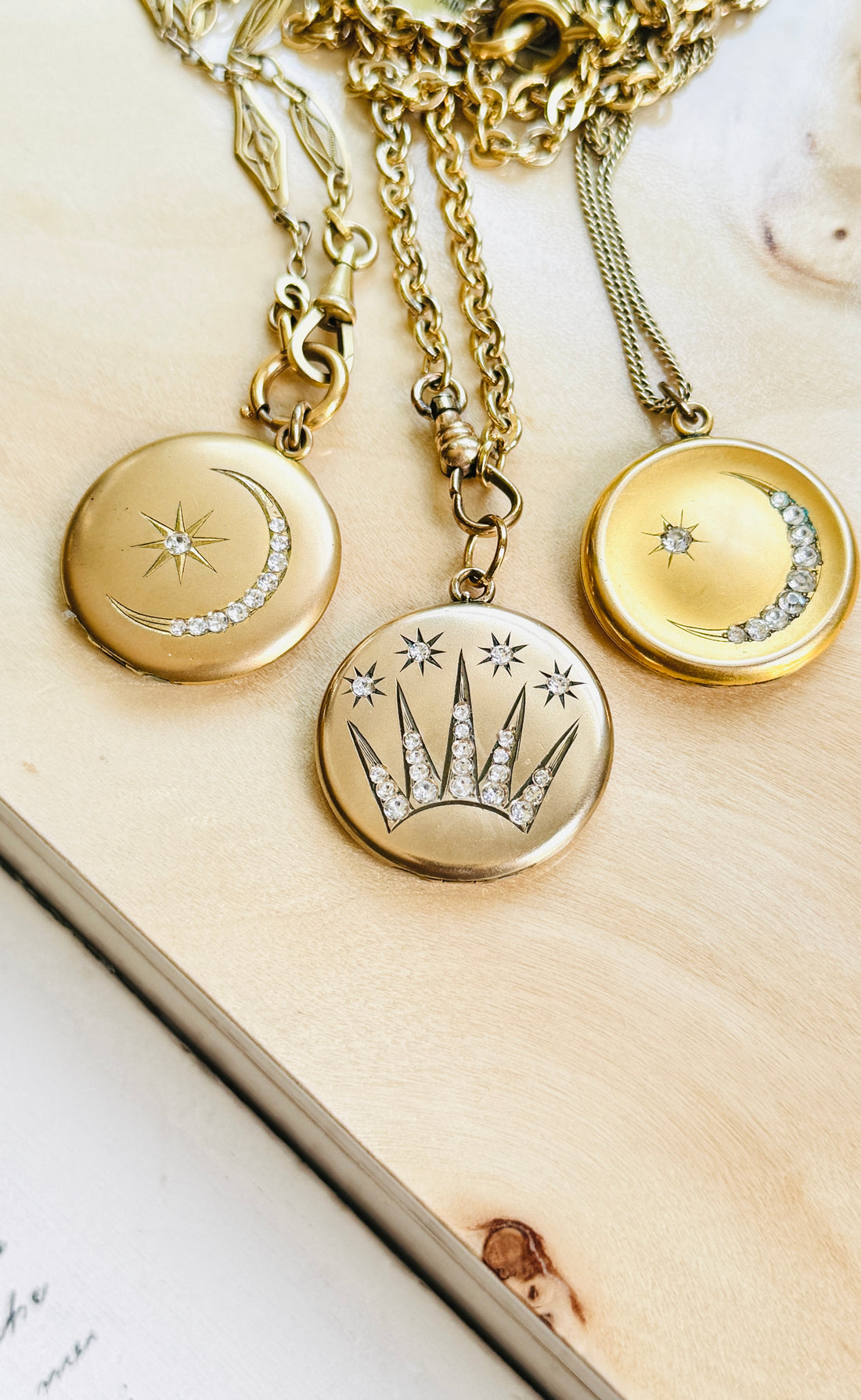 Collection of antique celestial lockets featuring Edwardian shooting star and crescent moon motifs in gold-filled finishes.
