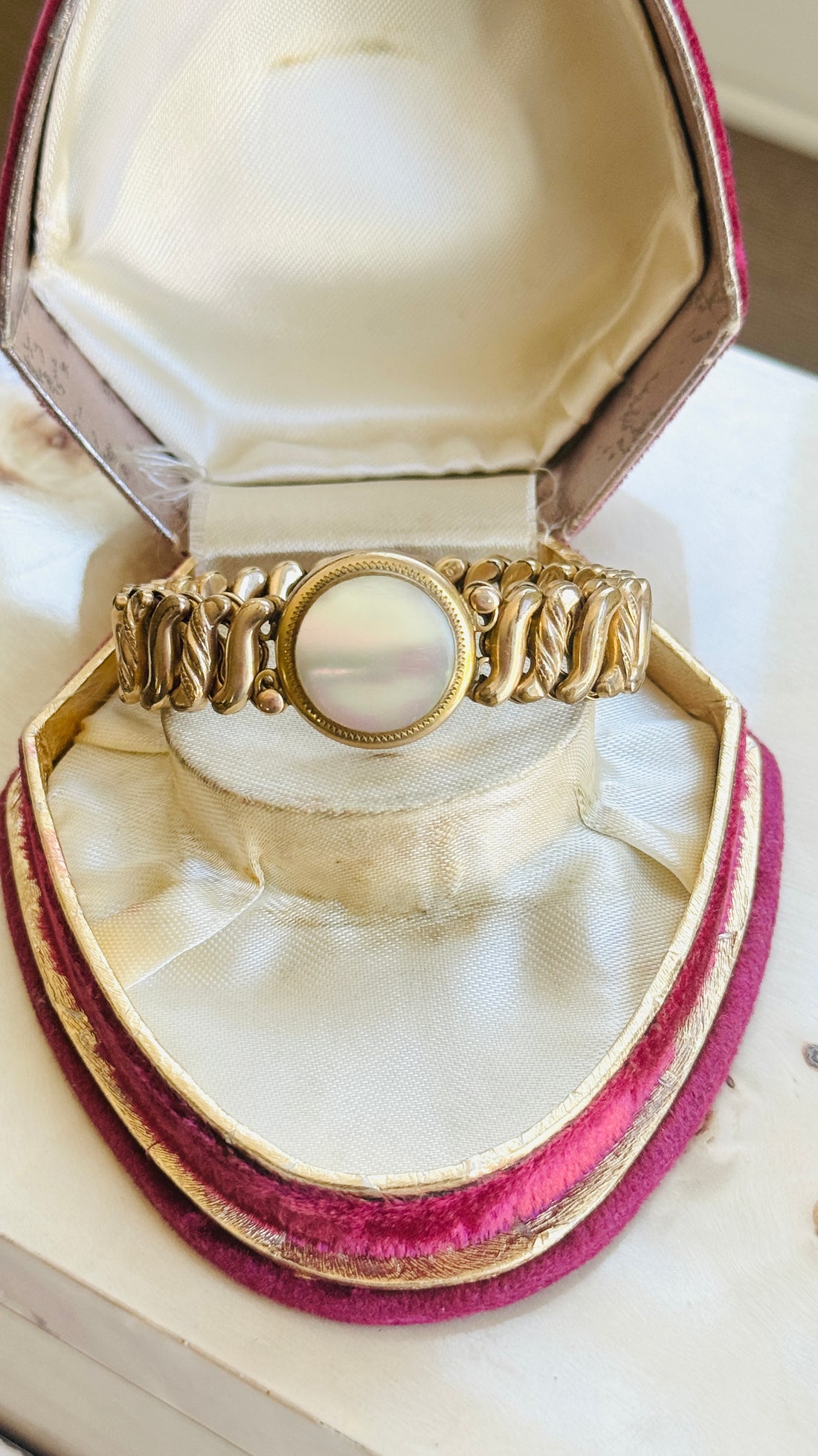 DFB Co. Carmen gold-filled sweetheart bracelet with mother of pearl center, displayed in antique jewelry box