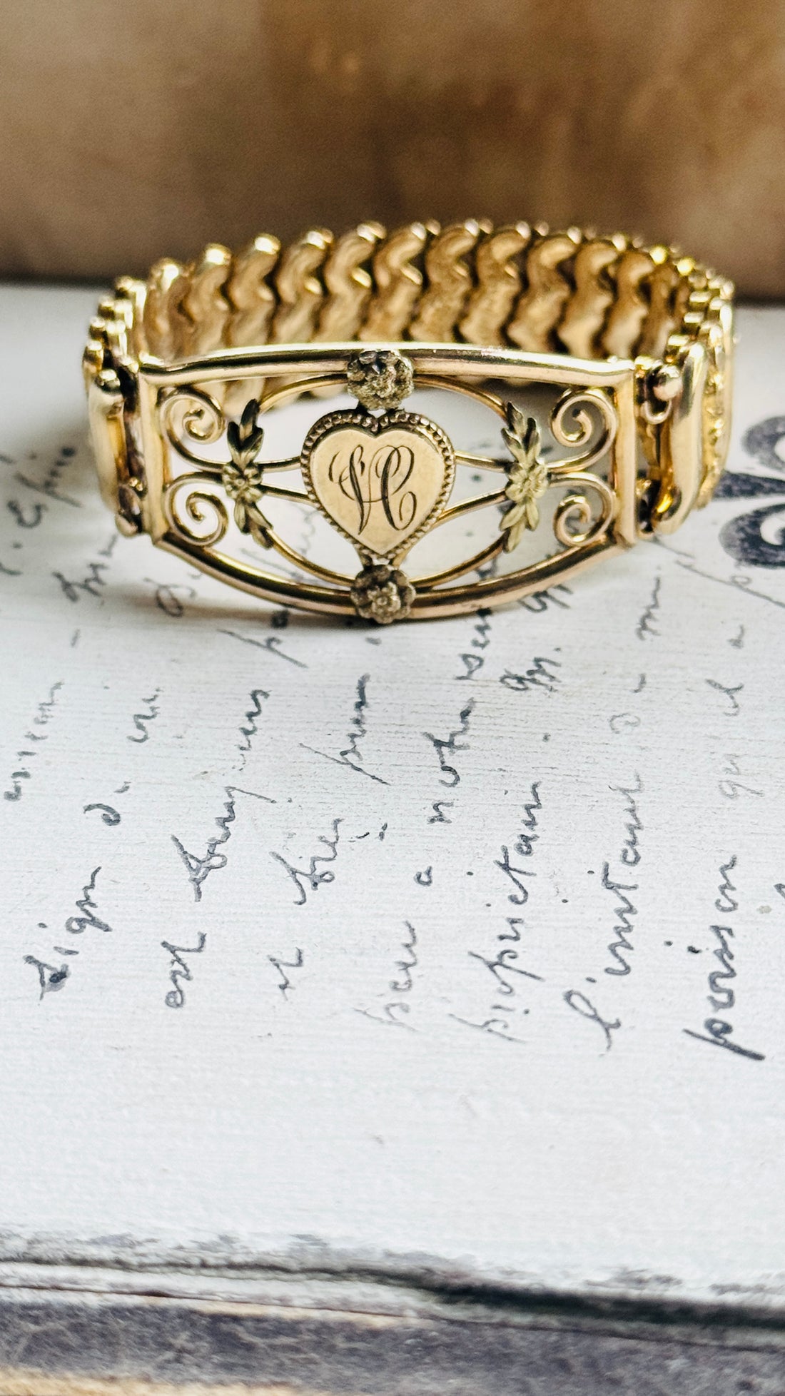 Detail of hand-worked scrollwork and rosette accents on 1940s sweetheart bracelet