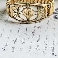 Detail of hand-worked scrollwork and rosette accents on 1940s sweetheart bracelet