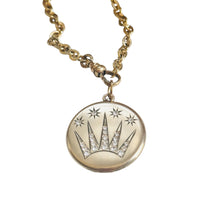 Edwardian celestial shooting star gold-filled locket paired with an antique watch chain featuring its original dog clip.

