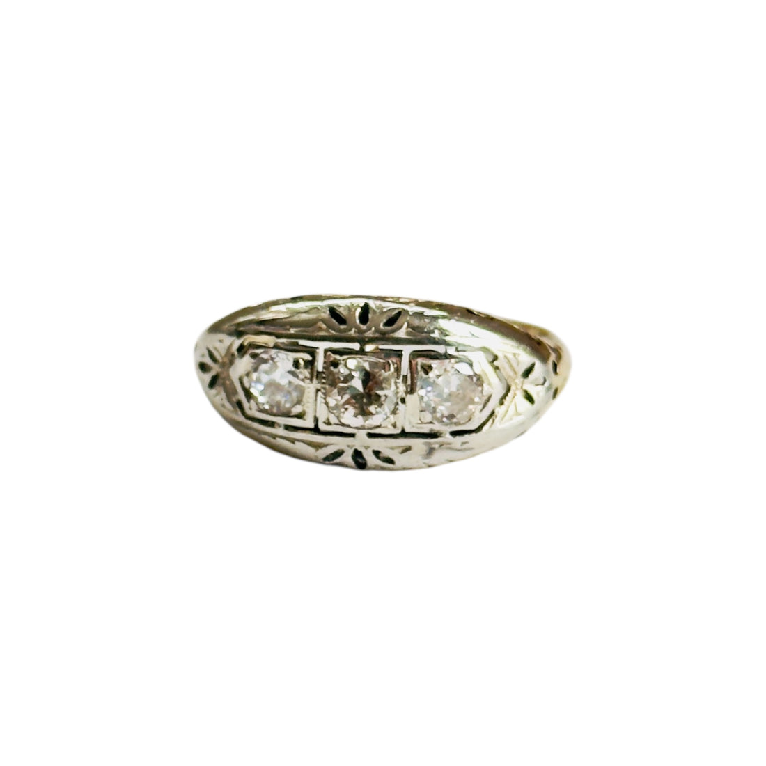 Edwardian three-stone diamond ring in two-tone 14K gold with filigree details