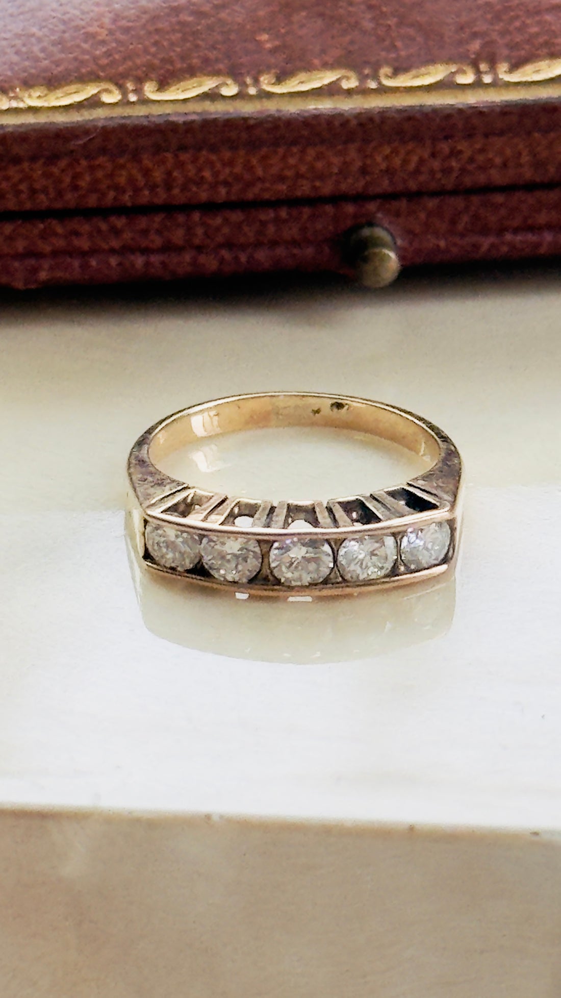 Estate 14K rose gold ring featuring five matched diamonds in graduated setting