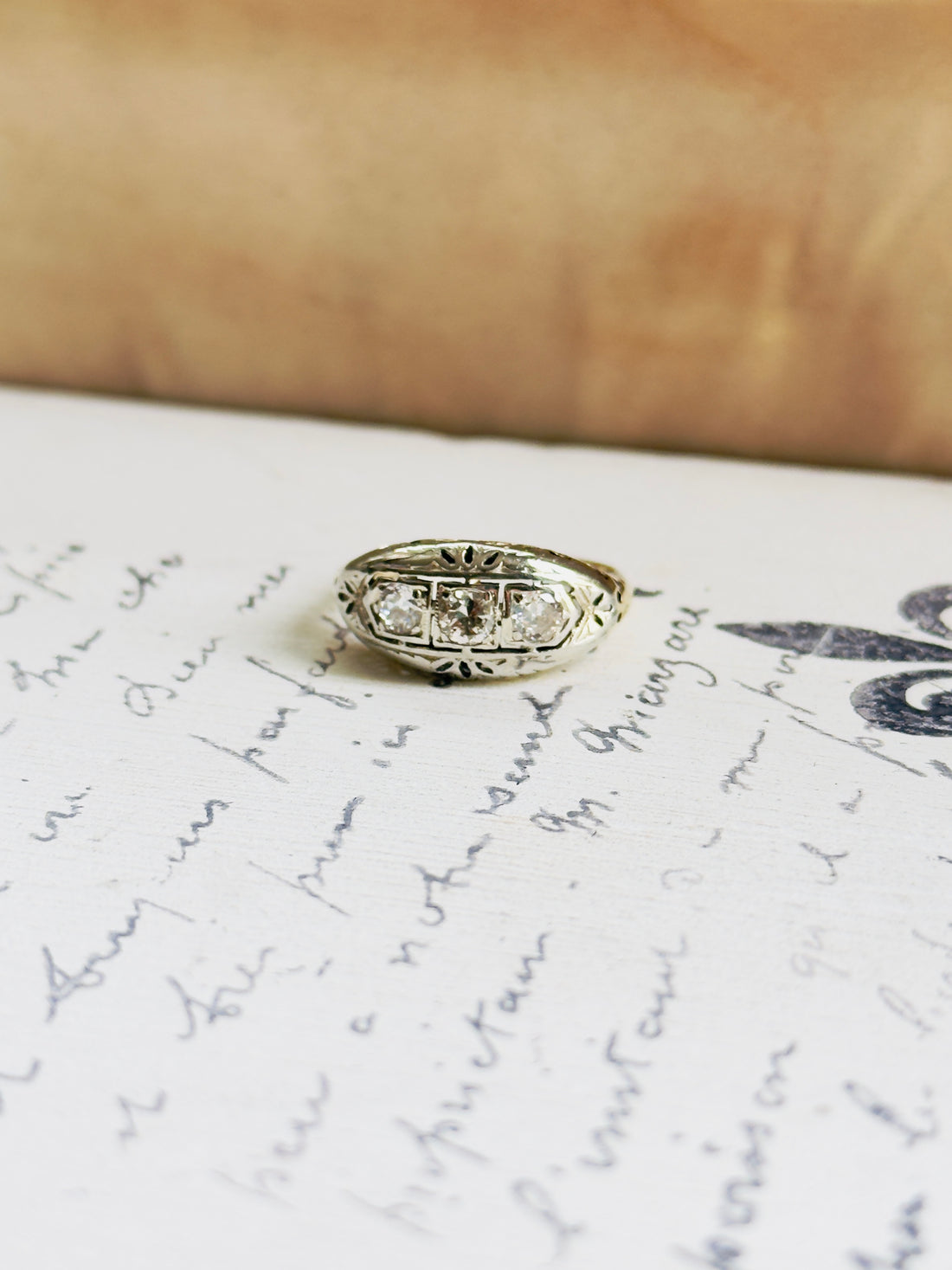 Estate three-stone diamond band in 14K gold with H color VS2 clarity stones