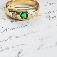 Flush set emerald and diamond ring in 14k yellow gold