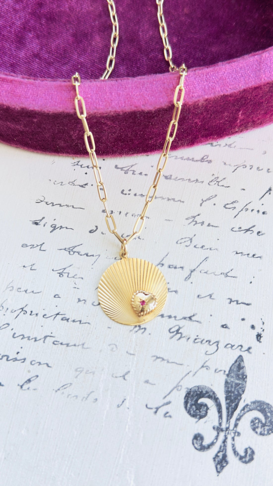 Fluted gold disc charm layered on paperclip chain