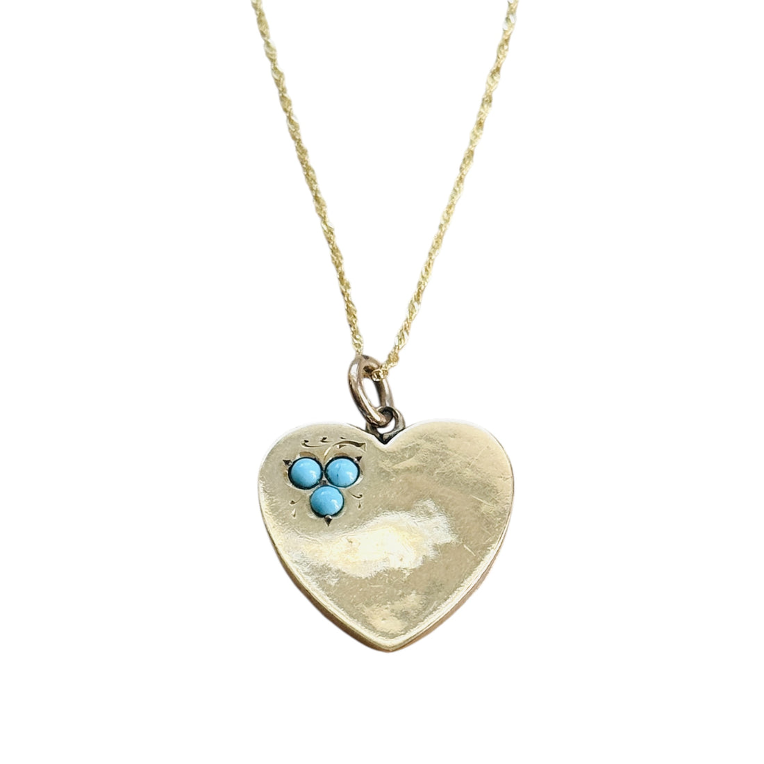 Front view of an antique English 9ct gold heart pendant with turquoise accents.