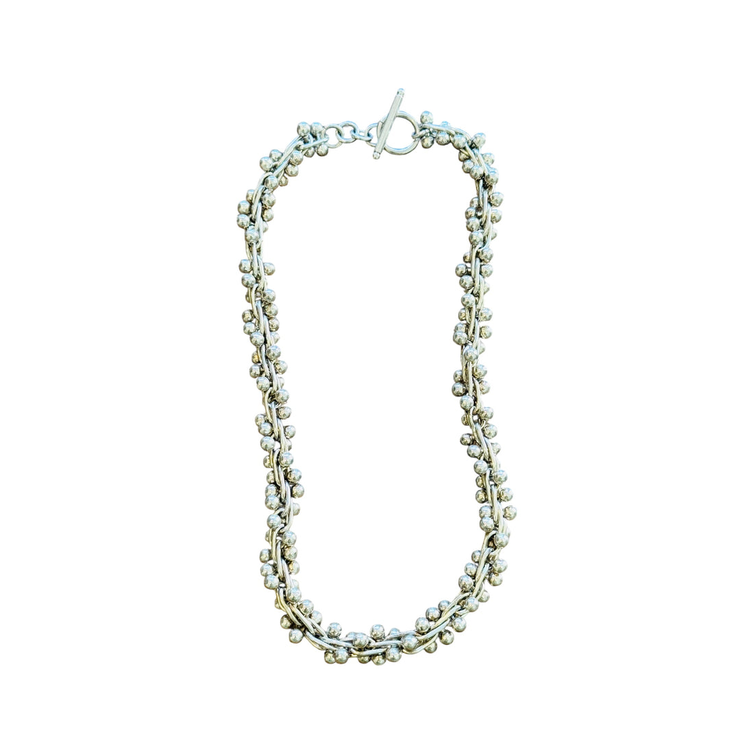 Full view of an 18-inch vintage sterling silver peppercorn necklace with toggle closure and chunky bead ball helix links.