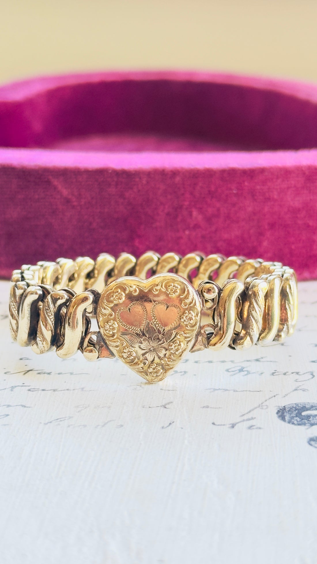 Gold filled sweetheart bracelet with heart shaped center and floral engraving