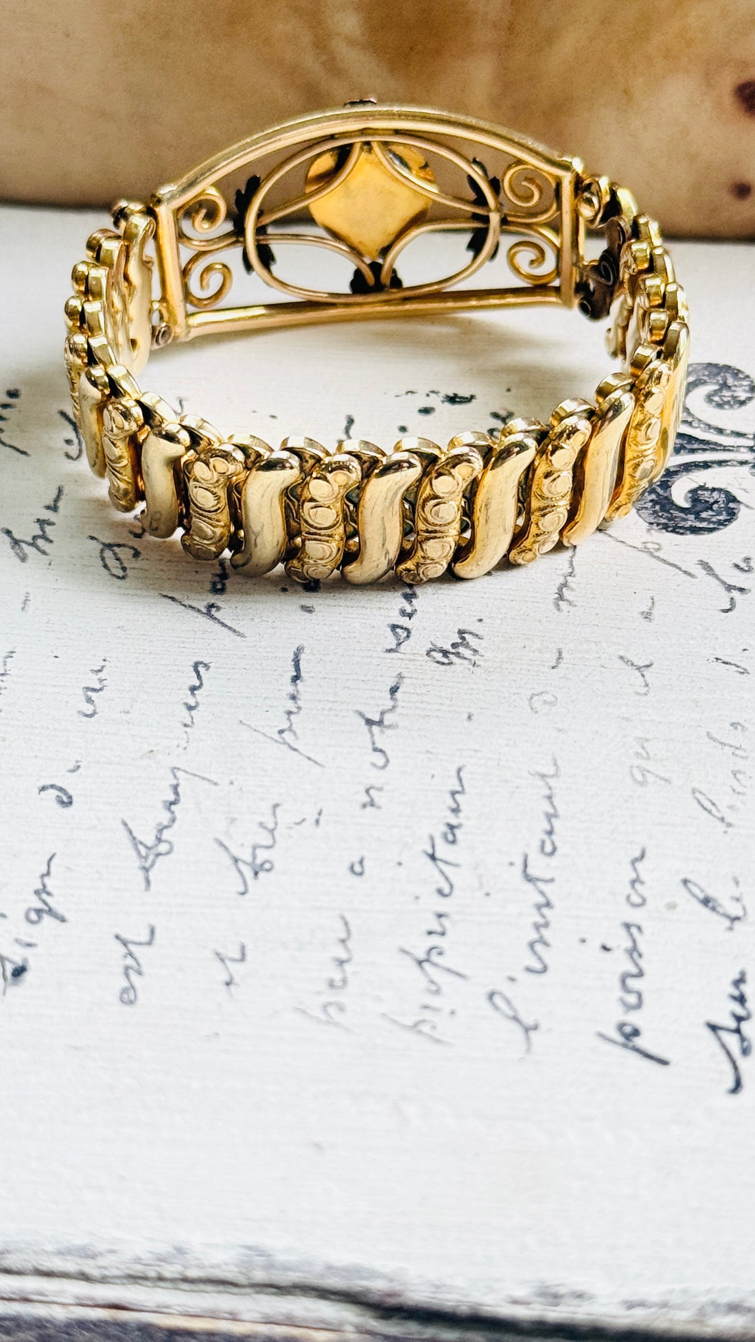 Gold filled sweetheart bracelet with open scrollwork and floral rosette detail