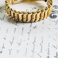Gold filled sweetheart bracelet with open scrollwork and floral rosette detail
