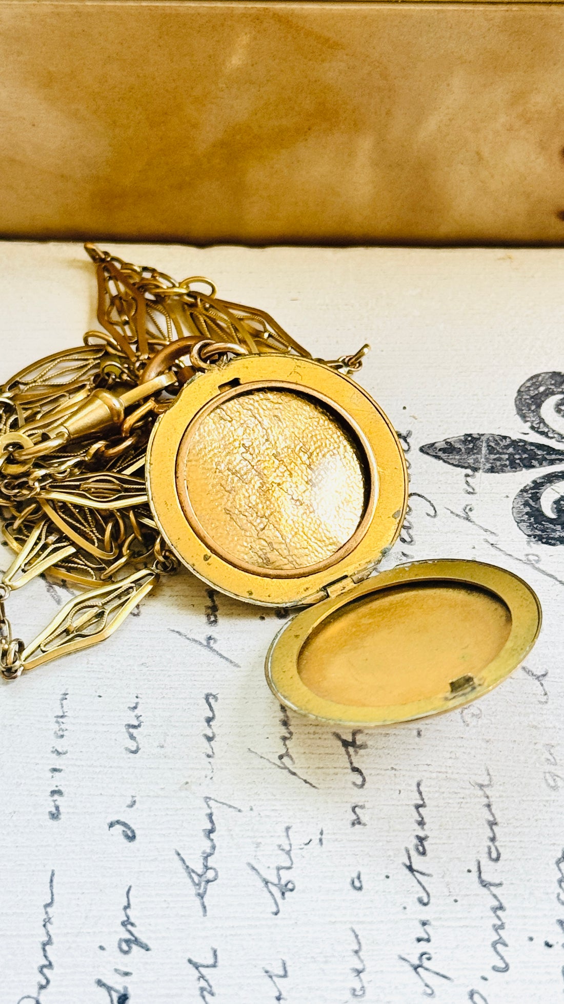 Interior of the Victorian crescent moon locket displaying the original photograph and compartment for keepsakes.