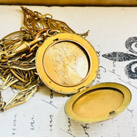 Interior of the Victorian crescent moon locket displaying the original photograph and compartment for keepsakes.