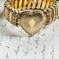 Ladifair gold filled sweetheart bracelet with engraved heart locket, displayed on antique paper"