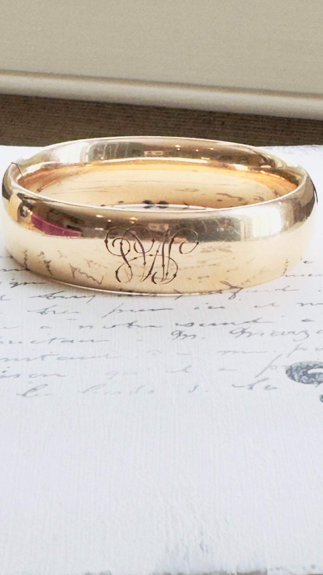 Back view showing engraved “ML” monogram on polished surface.