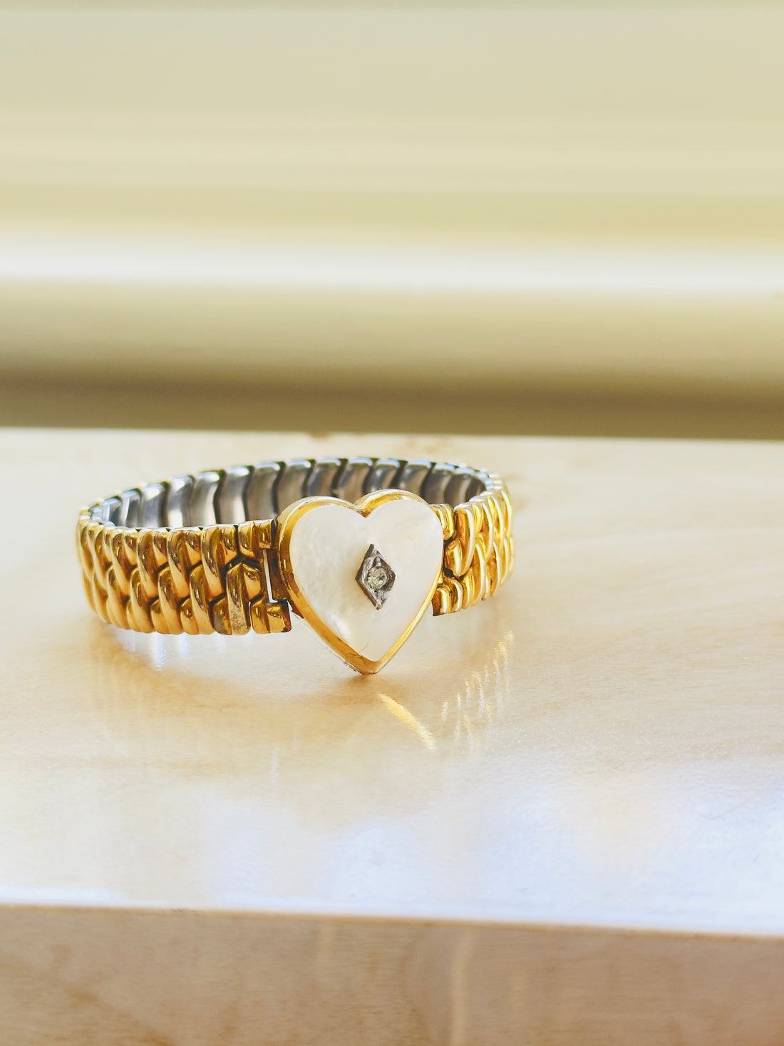 Mother of pearl heart bracelet with gold filled links close up