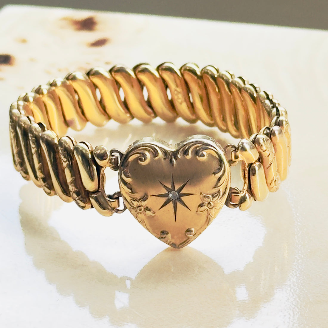 One of a kind vintage sweetheart bracelet with star-set diamond heart, hand-engraved floral scrollwork, gold-filled ribbed band