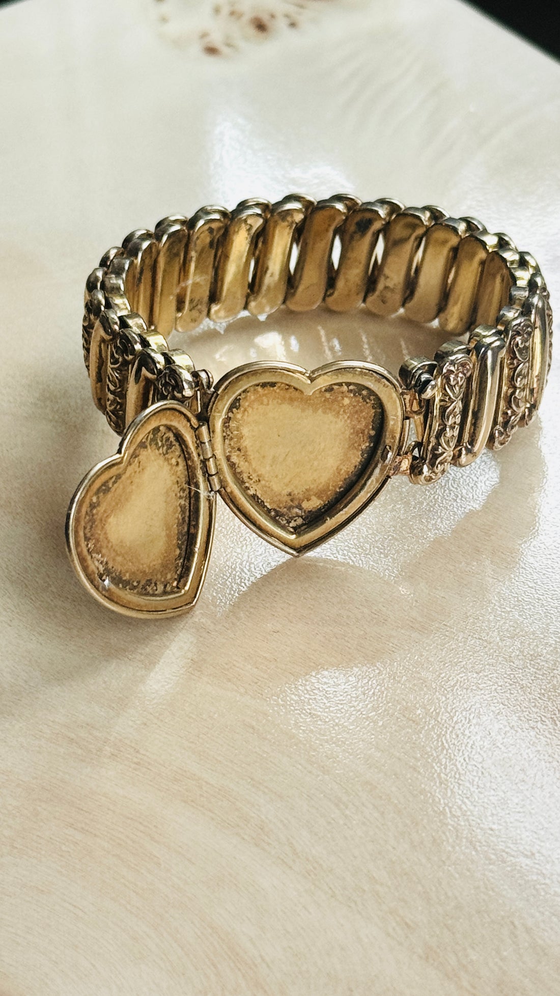Open heart locket on vintage Ladifair sweetheart bracelet, showing interior compartment