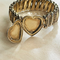 Open heart locket on vintage Ladifair sweetheart bracelet, showing interior compartment