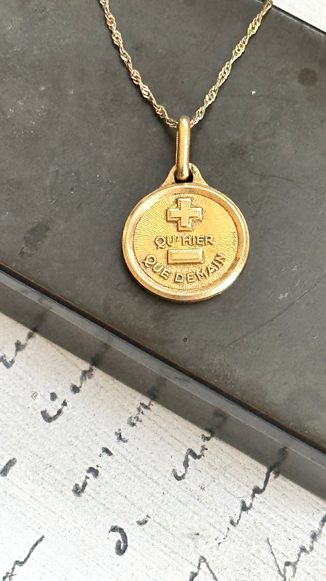 Original French Love Token by Alphonse Augis displayed on an 18k gold pendant with a 14k gold chain.