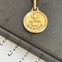 Original French Love Token by Alphonse Augis displayed on an 18k gold pendant with a 14k gold chain.