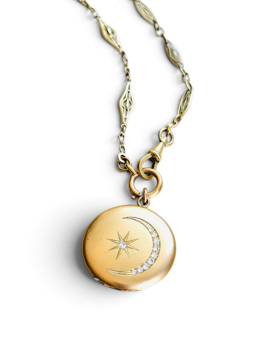 Original Victorian celestial crescent moon locket with antique French ORIA watch chain on white background.