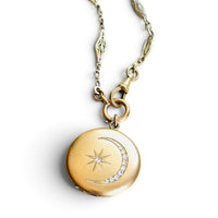 Original Victorian celestial crescent moon locket with antique French ORIA watch chain on white background.