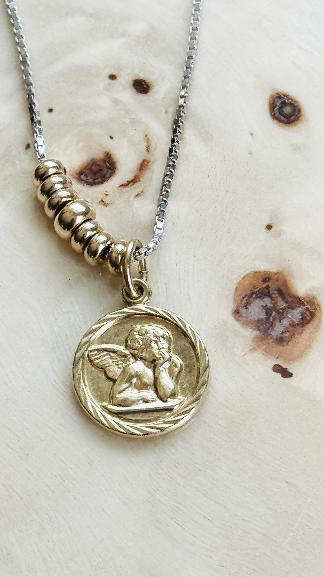 Original Victorian cherub pendant in 14k gold featuring the iconic pensive angel motif inspired by Raphael's Sistine Madonna.
