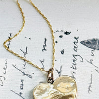 Reverse of antique English 9ct gold heart pendant showing Birmingham hallmarks and maker's mark.