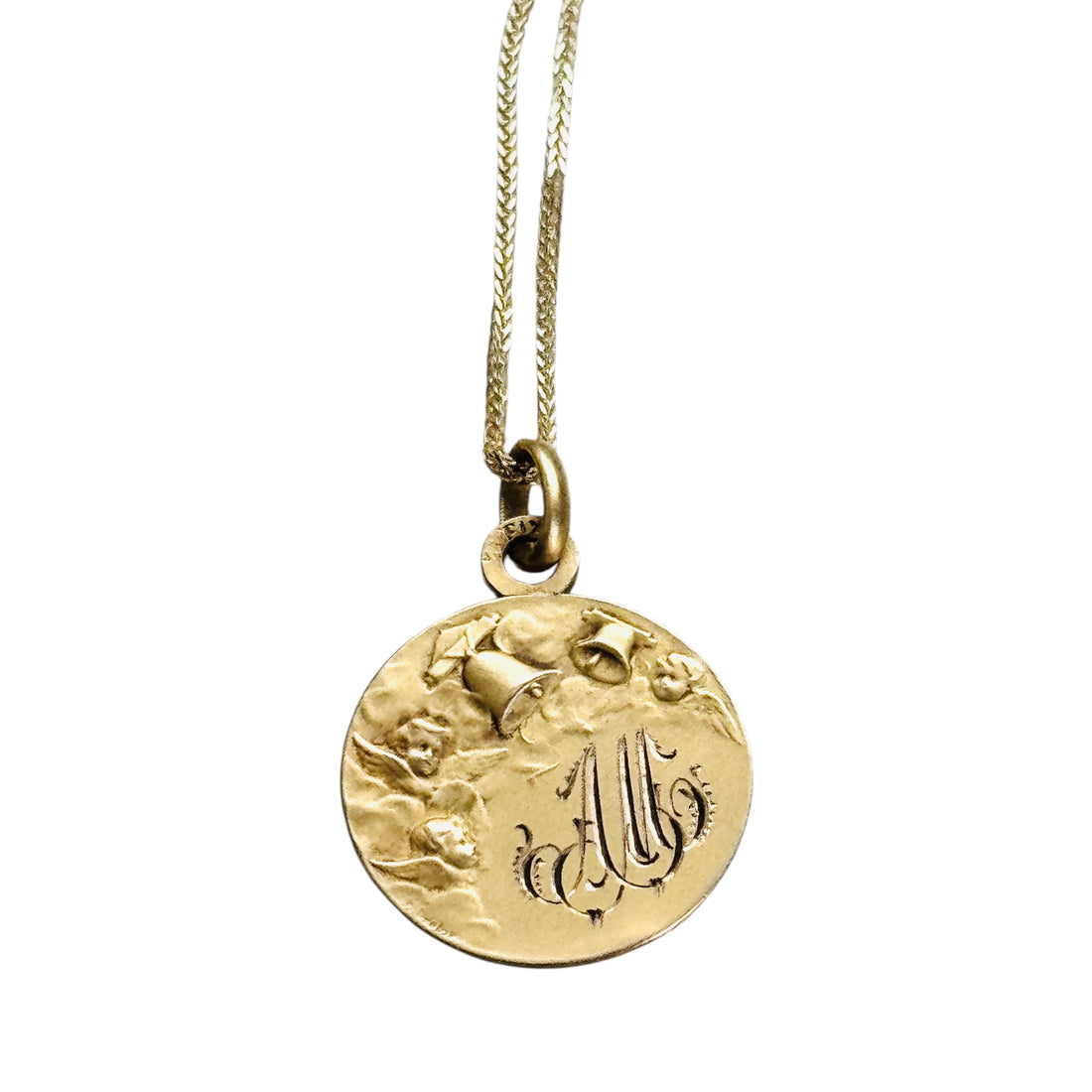 Reverse of antique FIX cherub medal showing the original engraved monogram.