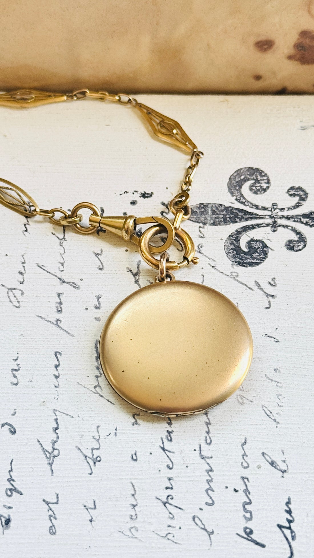 Reverse of the original Victorian gold-filled crescent moon locket showing the smooth, unmonogrammed back.