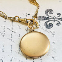 Reverse of the original Victorian gold-filled crescent moon locket showing the smooth, unmonogrammed back.