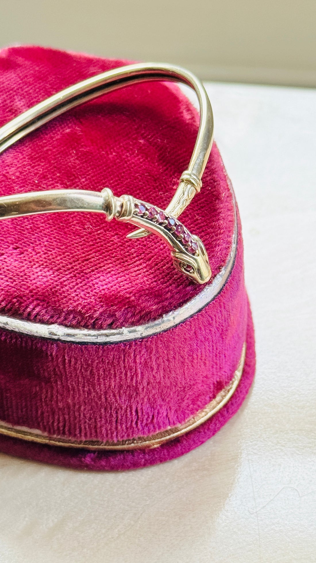 Side profile of a vintage gold snake bracelet highlighting its flexible sprung construction and wrap design.